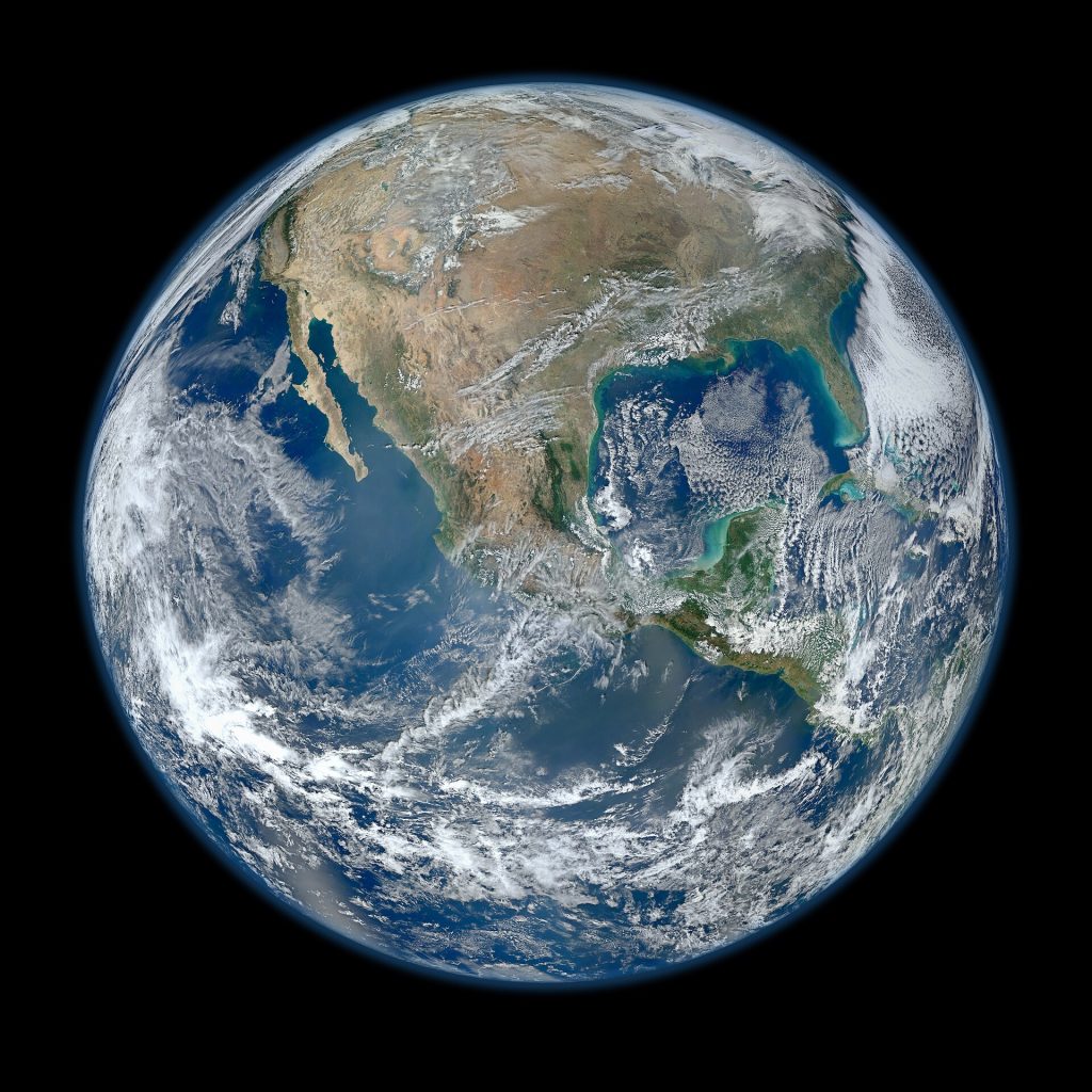 A satellite in orbit above Earth with solar panels extended